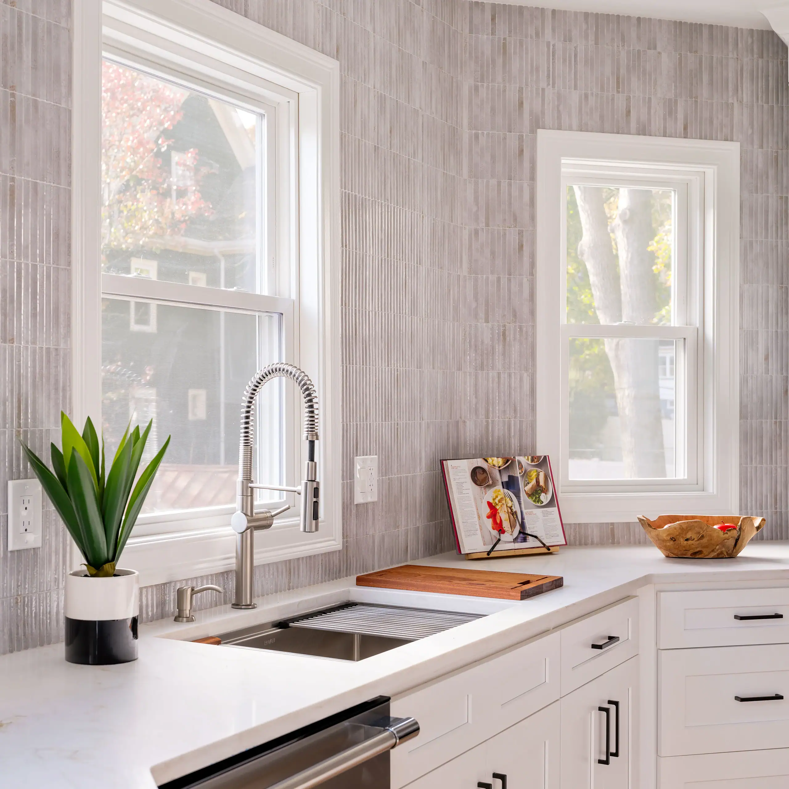 Boston seller reviewing lead paint disclosure in modern kitchen with white cabinetry